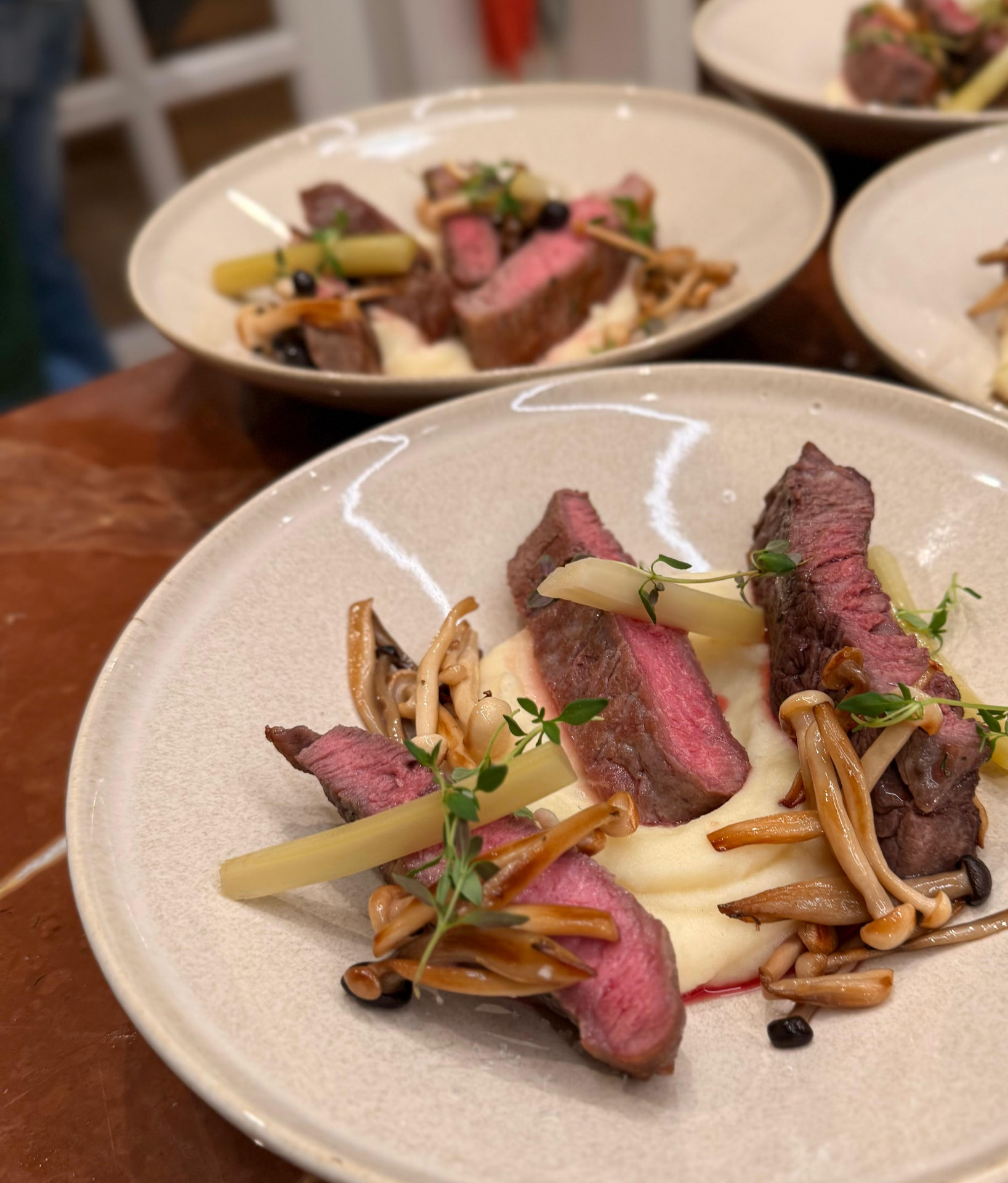 A plated beef main course prepared at a private dining event