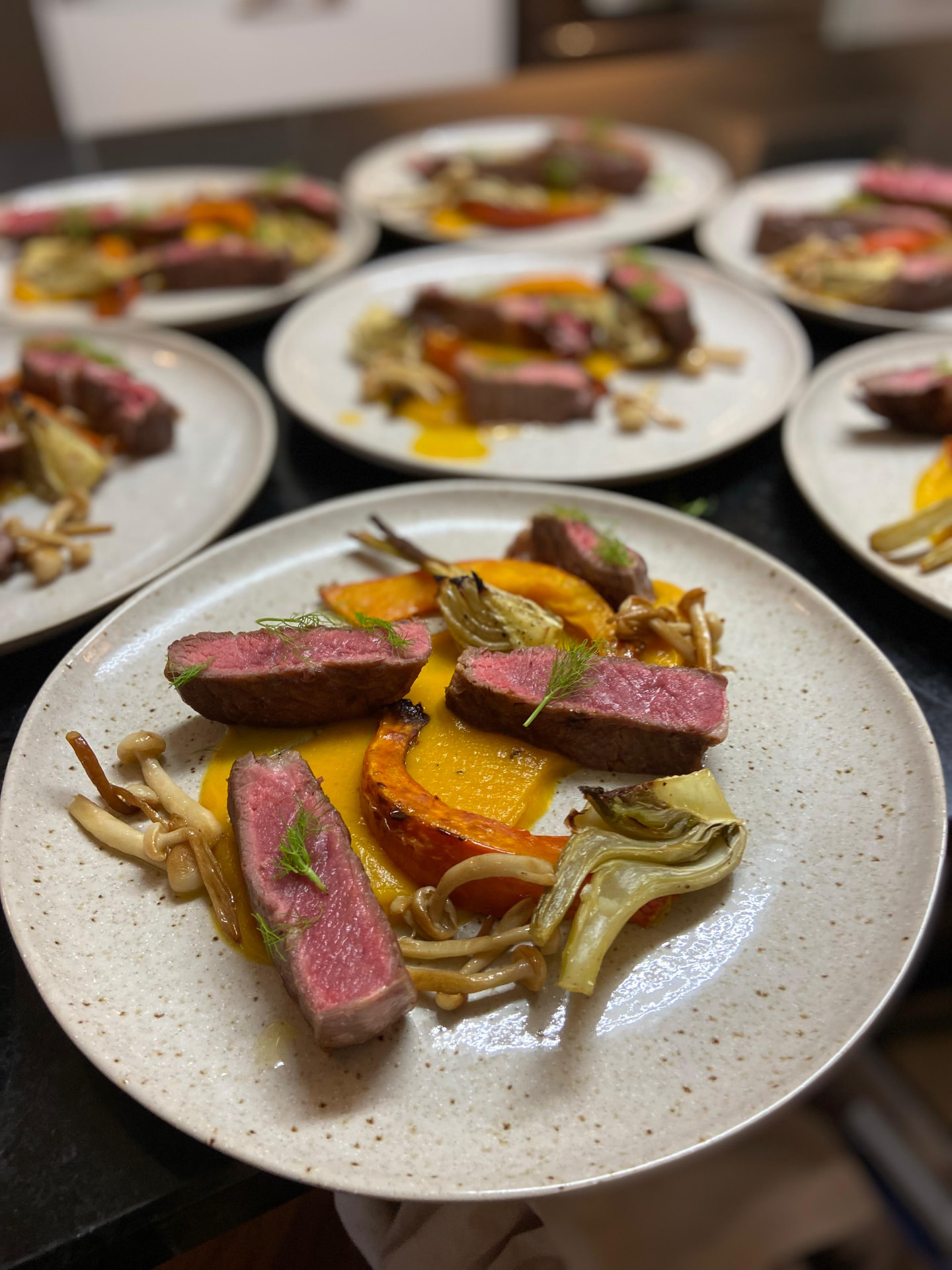Multiple private chef dinner plates prepared for service