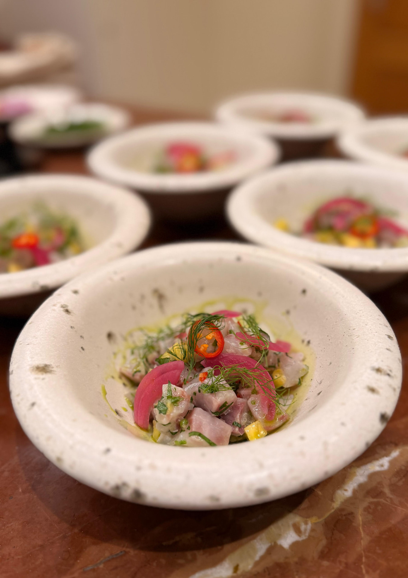 Freshly prepared private dining starter presented in a handmade ceramic bowl
